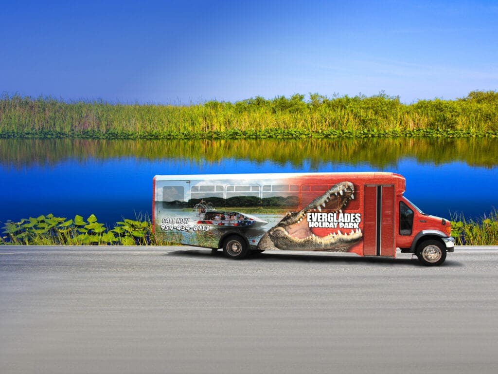 Colorful Everglades vip tour shuttle van with an alligator and airboat tour image on the side